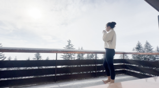 me on a balcony drinking coffee. winter landscape. snow. 